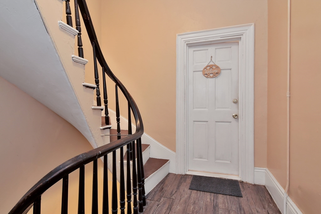 276 Broadway Lawrence, MA 01841 - Photo 4 of 27 a view of an entryway with wooden floor and stairs