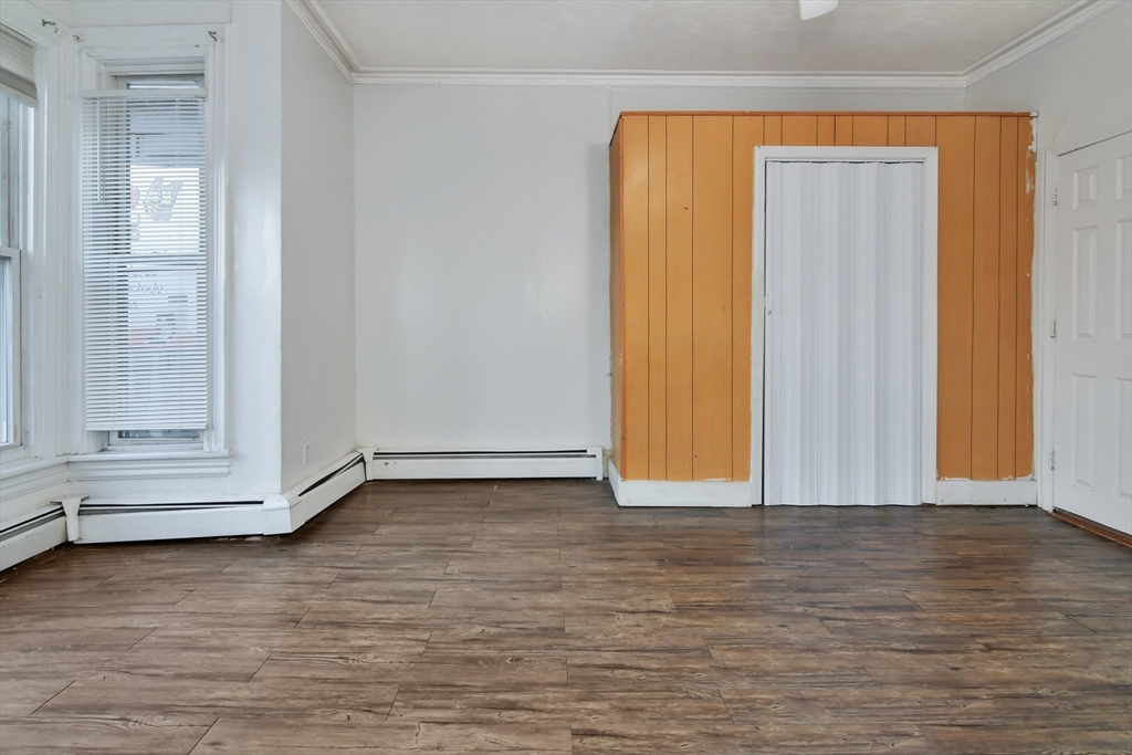 276 Broadway Lawrence, MA 01841 - Photo 6 of 27 a view of an empty room with wooden floor and window