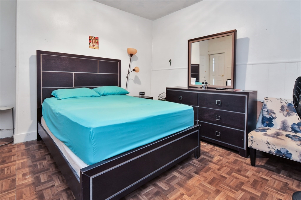 276 Broadway Lawrence, MA 01841 - Photo 8 of 27 a bed room with a bed and a mirror