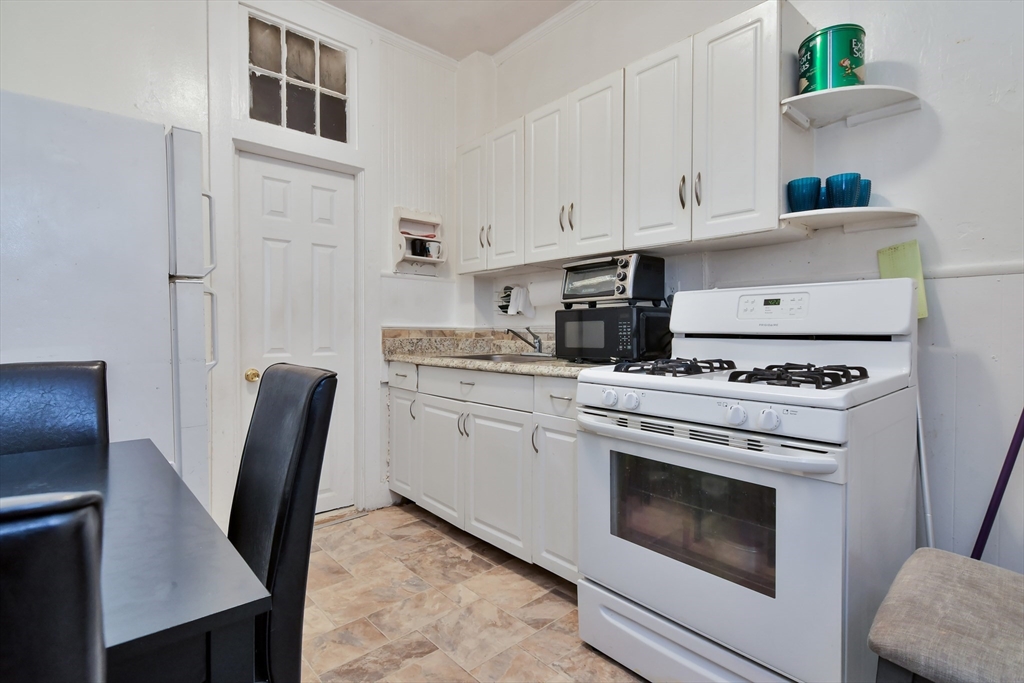 276 Broadway Lawrence, MA 01841 - Photo 9 of 27 a kitchen with cabinets appliances and furniture