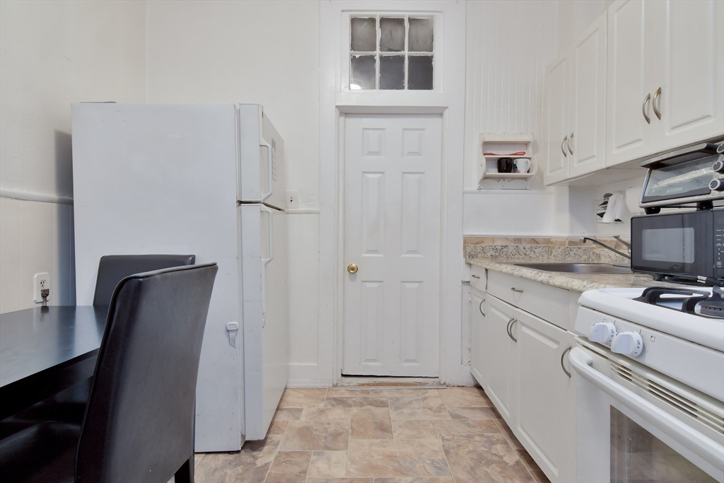 276 Broadway Lawrence, MA 01841 - Photo 10 of 27 a view of kitchen with refrigerator cabinets and furniture