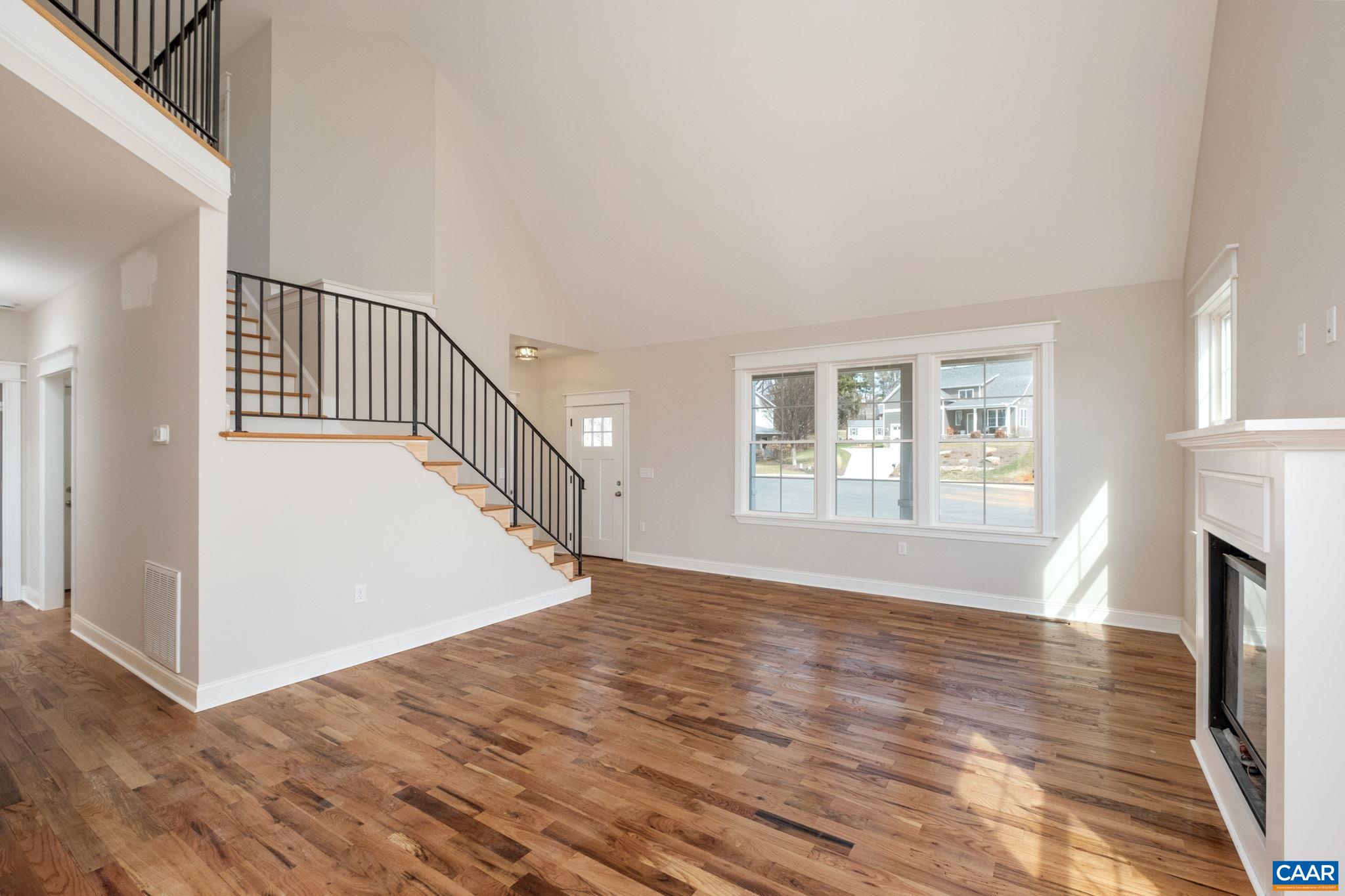 1004 High Point Court Waynesboro, VA 22980 - Photo 5 of 39 Large great room with high ceilings, hardwood floors, plenty of windows for natural light, a fireplace with granite mantel.
