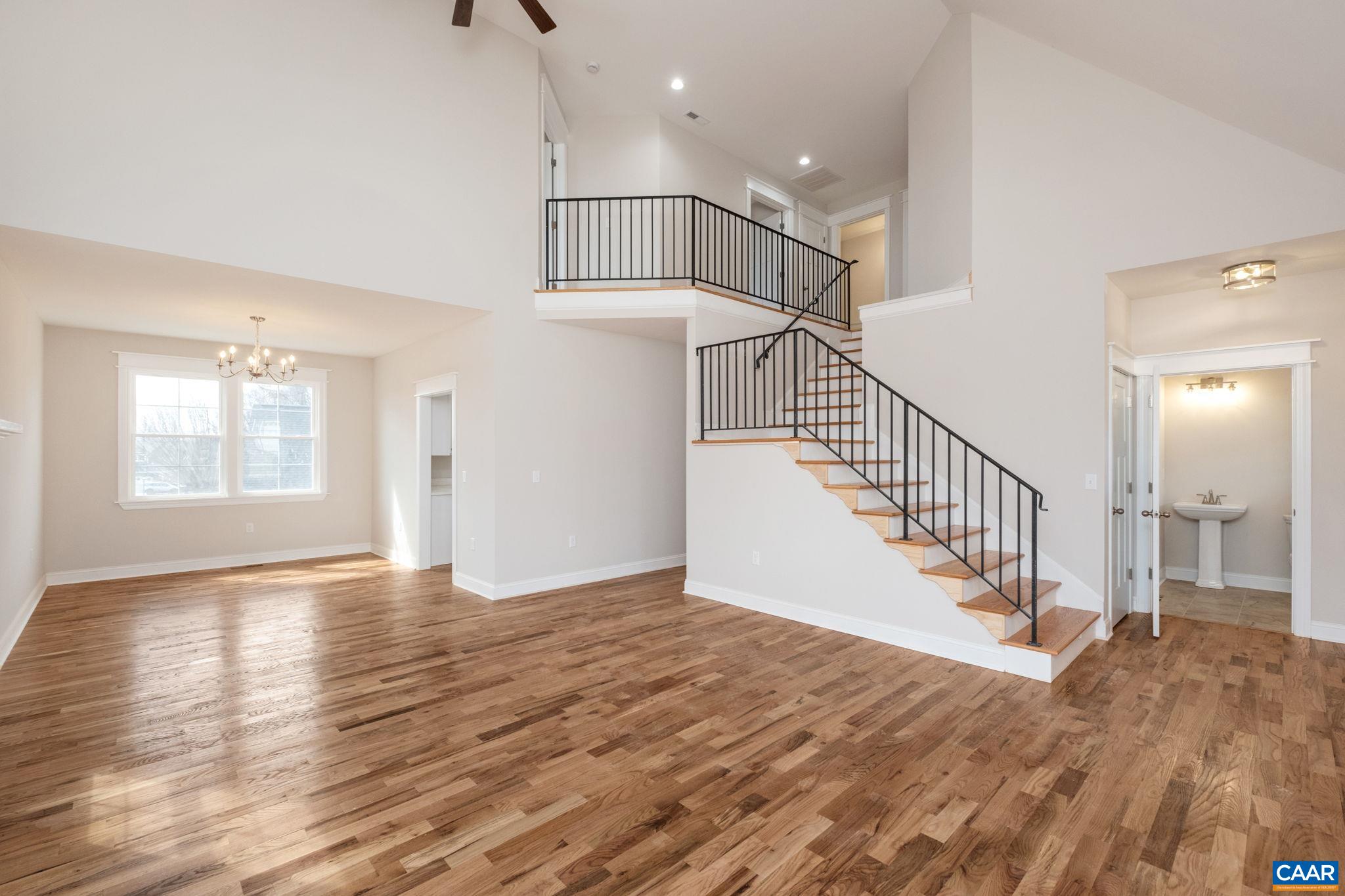 1004 High Point Court Waynesboro, VA 22980 - Photo 6 of 39 Large great room with high ceilings, hardwood floors, plenty of windows for natural light, a fireplace with granite mantel. Looking toward the dining room.