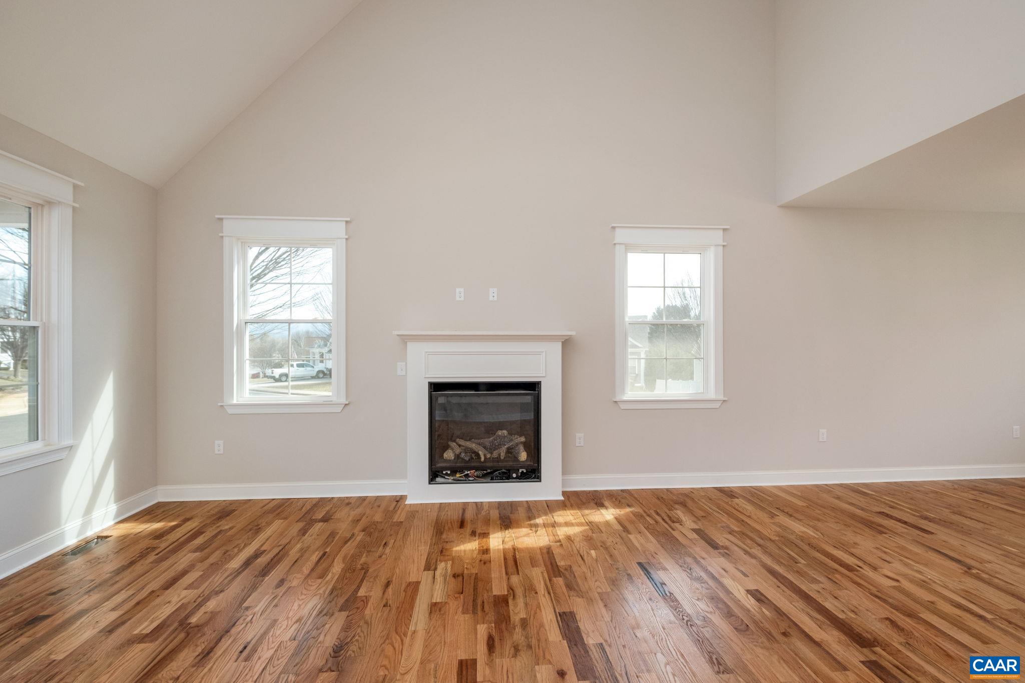 1004 High Point Court Waynesboro, VA 22980 - Photo 8 of 39 an empty room with wooden floor windows and fireplace