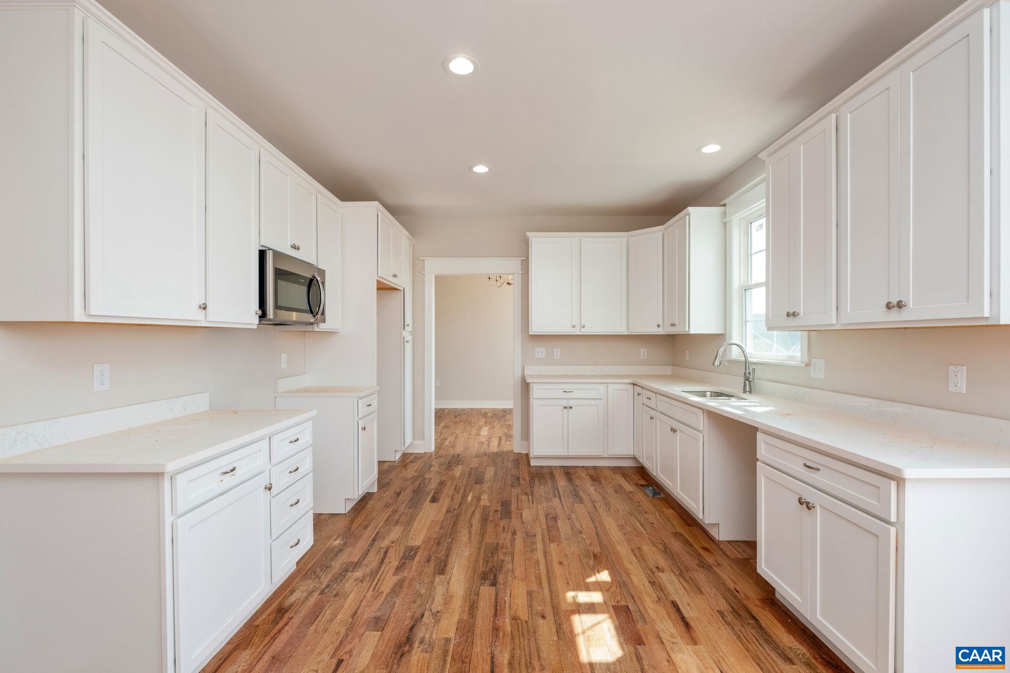 1004 High Point Court Waynesboro, VA 22980 - Photo 10 of 39 a kitchen with wooden floors and white appliances