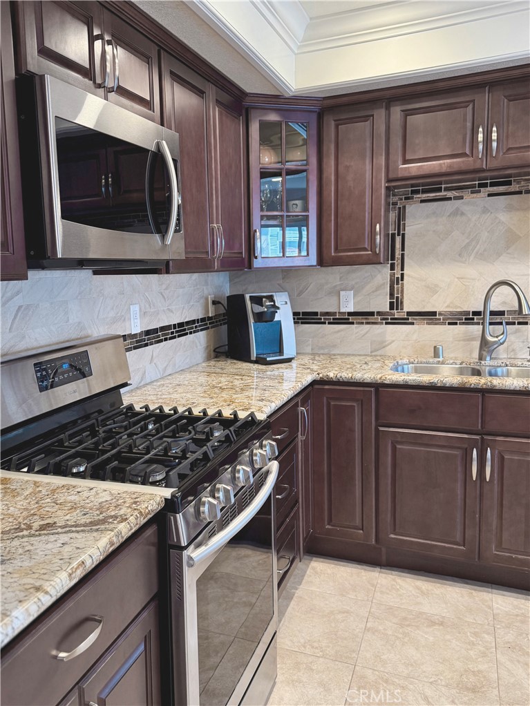 24612 Harbor View Drive, Unit 55C Dana Point, CA 92629 - Photo 9 of 71 a kitchen with stainless steel appliances granite countertop a sink stove and microwave