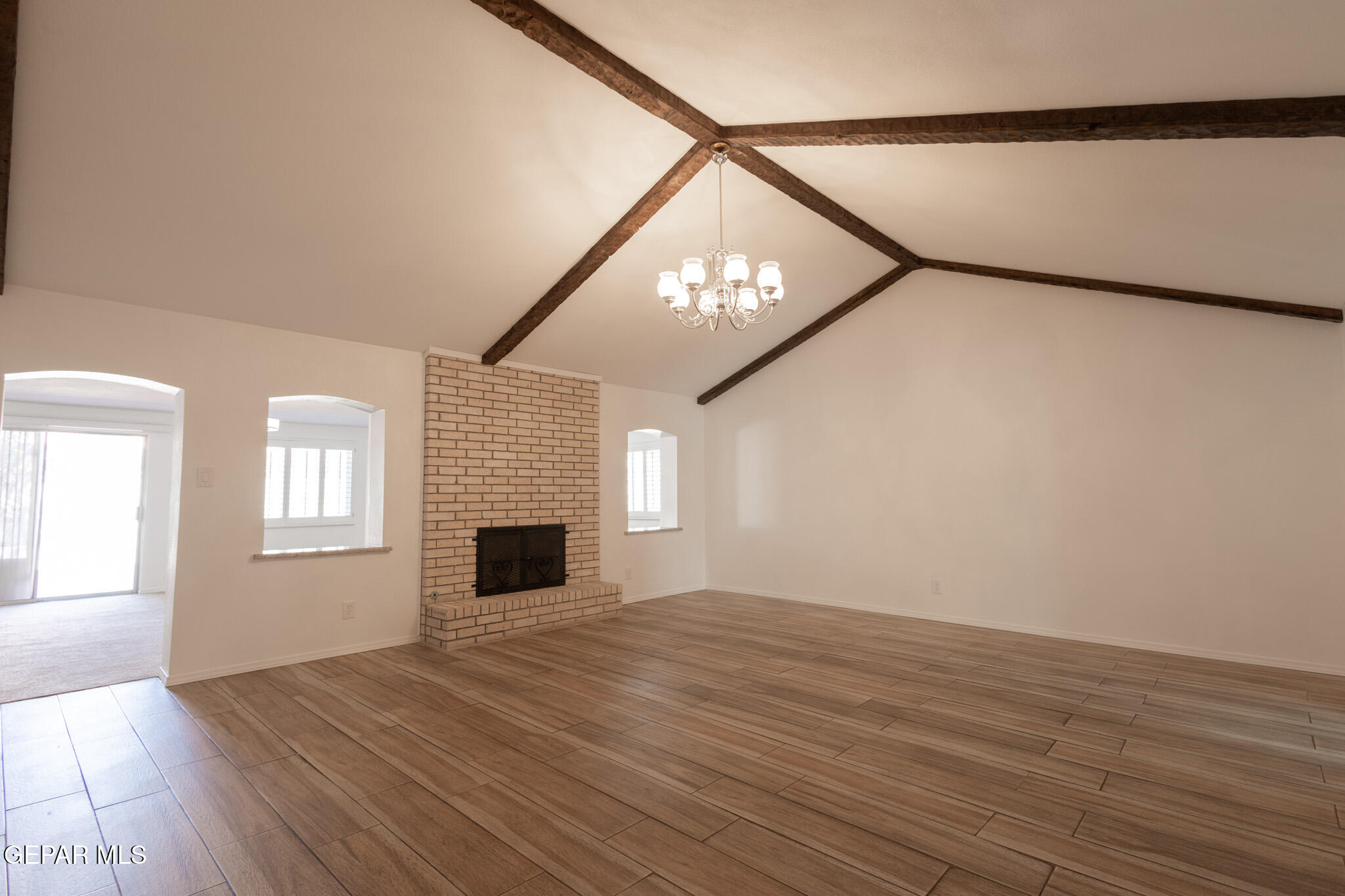 14829 Kingston Road Horizon City, TX 79928 - Photo 19 of 34 a view of an empty room with wooden floor and a window