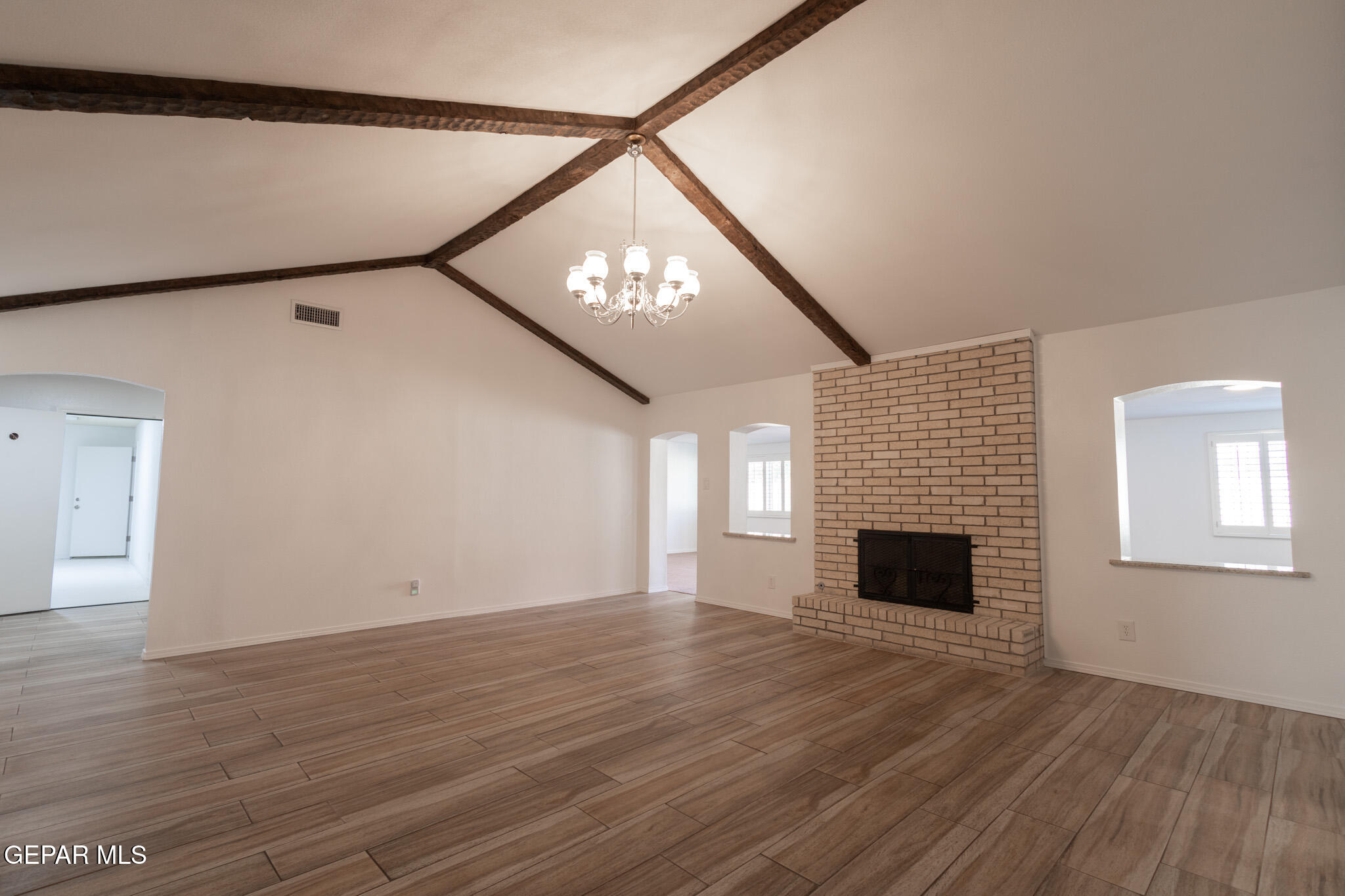 14829 Kingston Road Horizon City, TX 79928 - Photo 20 of 34 a view of empty room with wooden floor and fireplace