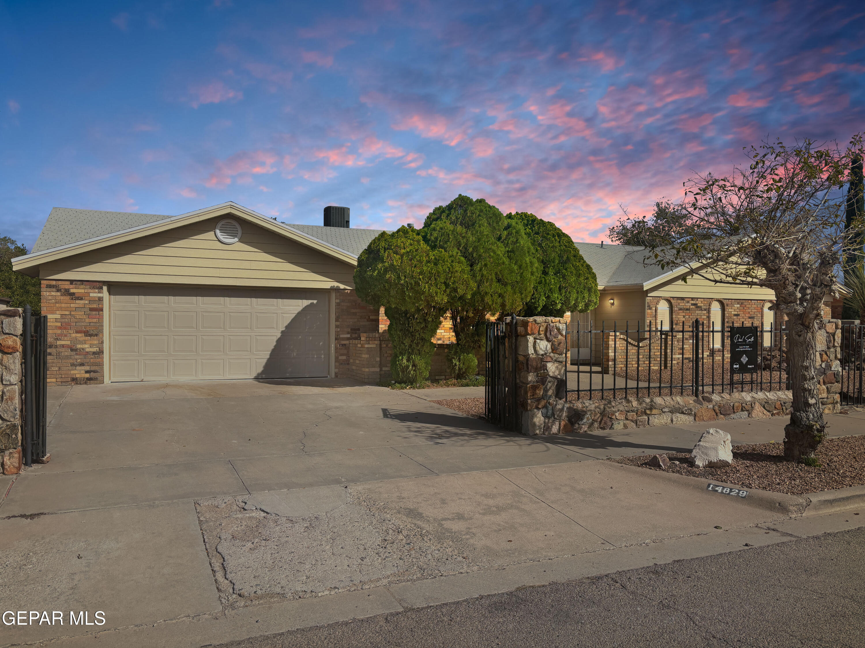 14829 Kingston Road Horizon City, TX 79928 - Photo 2 of 34 a front view of a house with a yard and garage