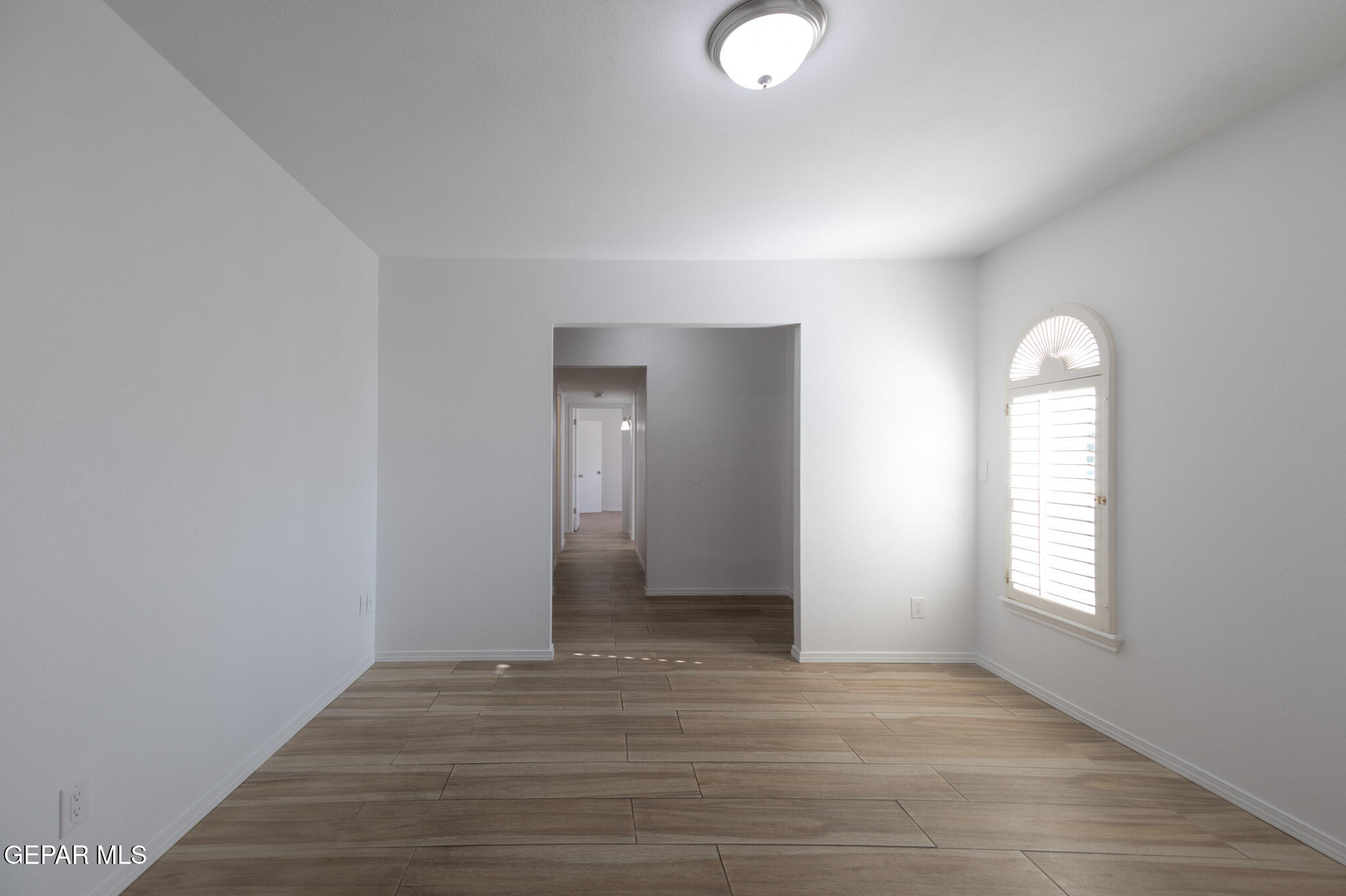 14829 Kingston Road Horizon City, TX 79928 - Photo 7 of 34 an empty room with wooden floor and windows