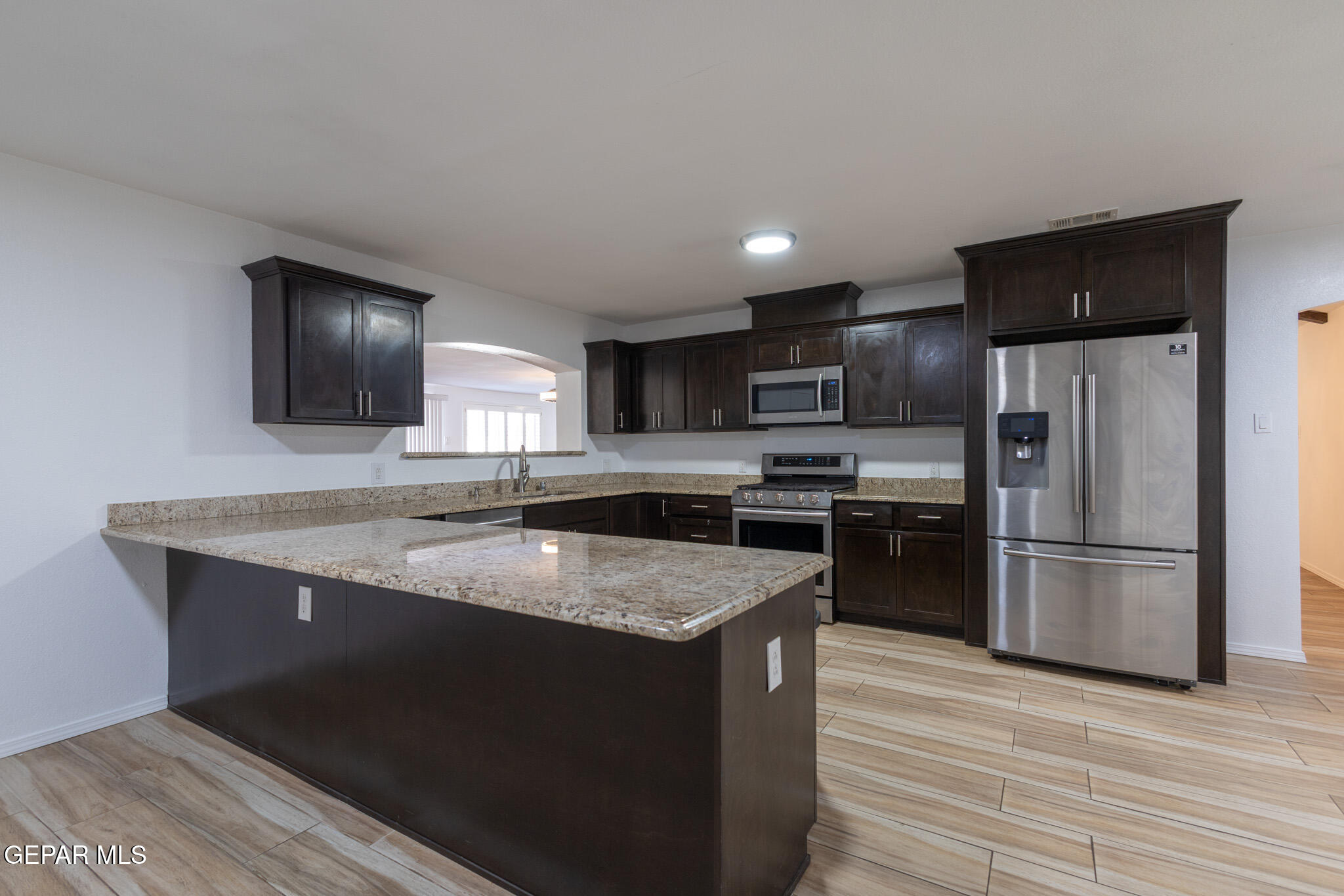 14829 Kingston Road Horizon City, TX 79928 - Photo 8 of 34 a kitchen with stainless steel appliances granite countertop a sink stove and refrigerator