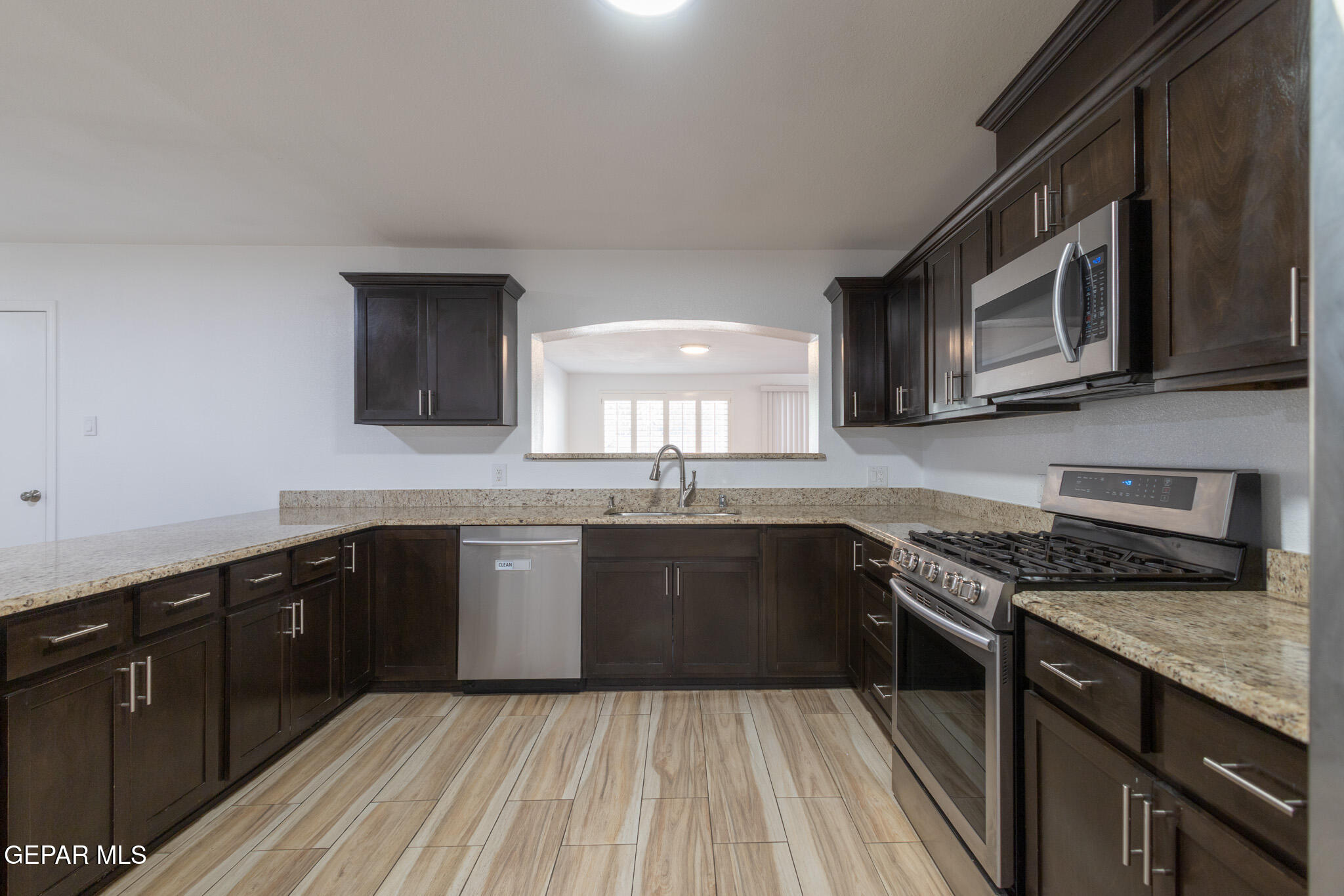 14829 Kingston Road Horizon City, TX 79928 - Photo 9 of 34 a kitchen with stainless steel appliances granite countertop wooden cabinets a stove top oven and granite counter tops