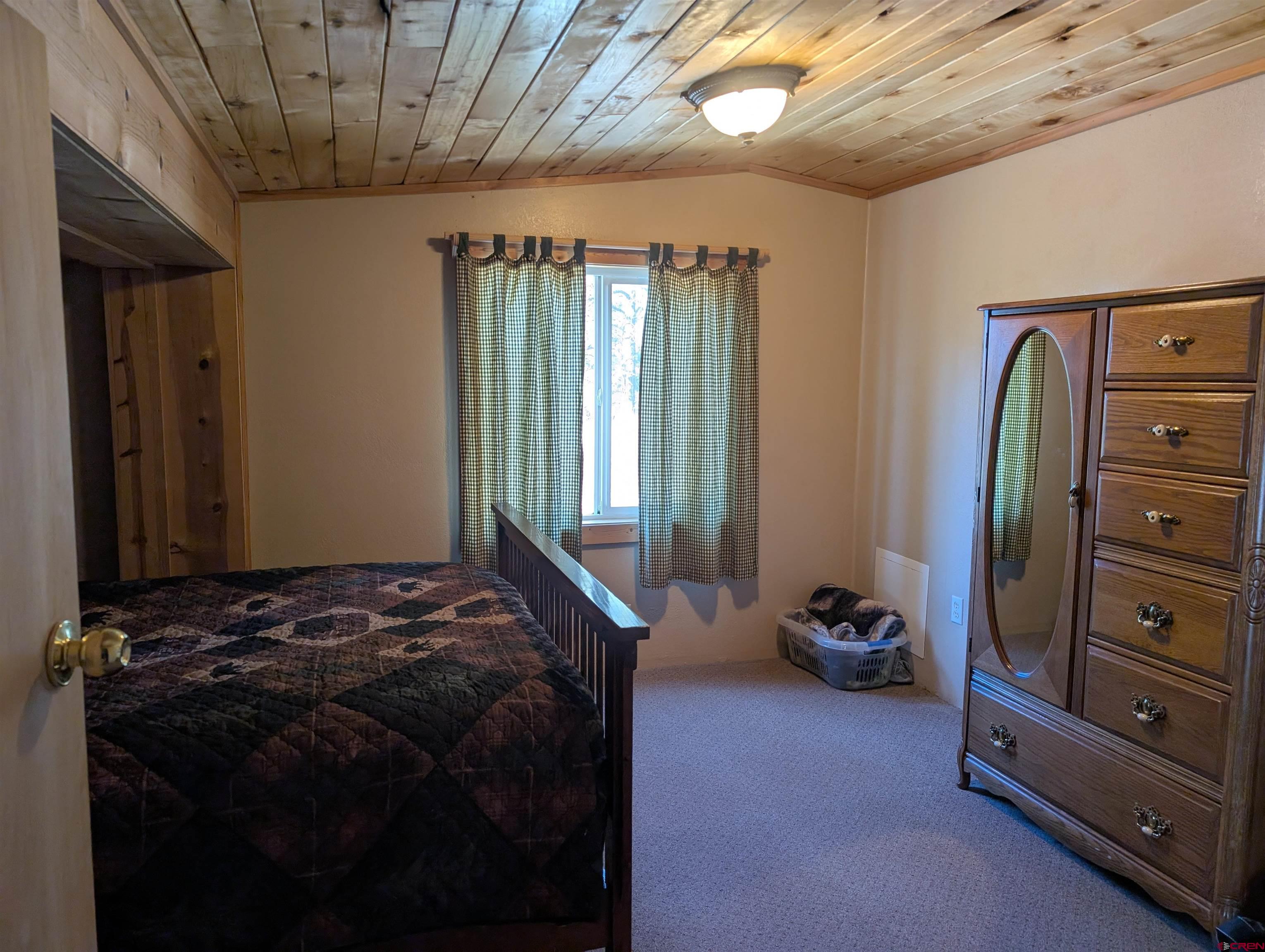 472 Haystack Circle Pagosa Springs, CO 81147 - Photo 15 of 31 a bedroom with a bed and a closet