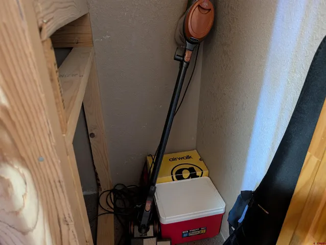 a view of a wooden door and chair in the patio