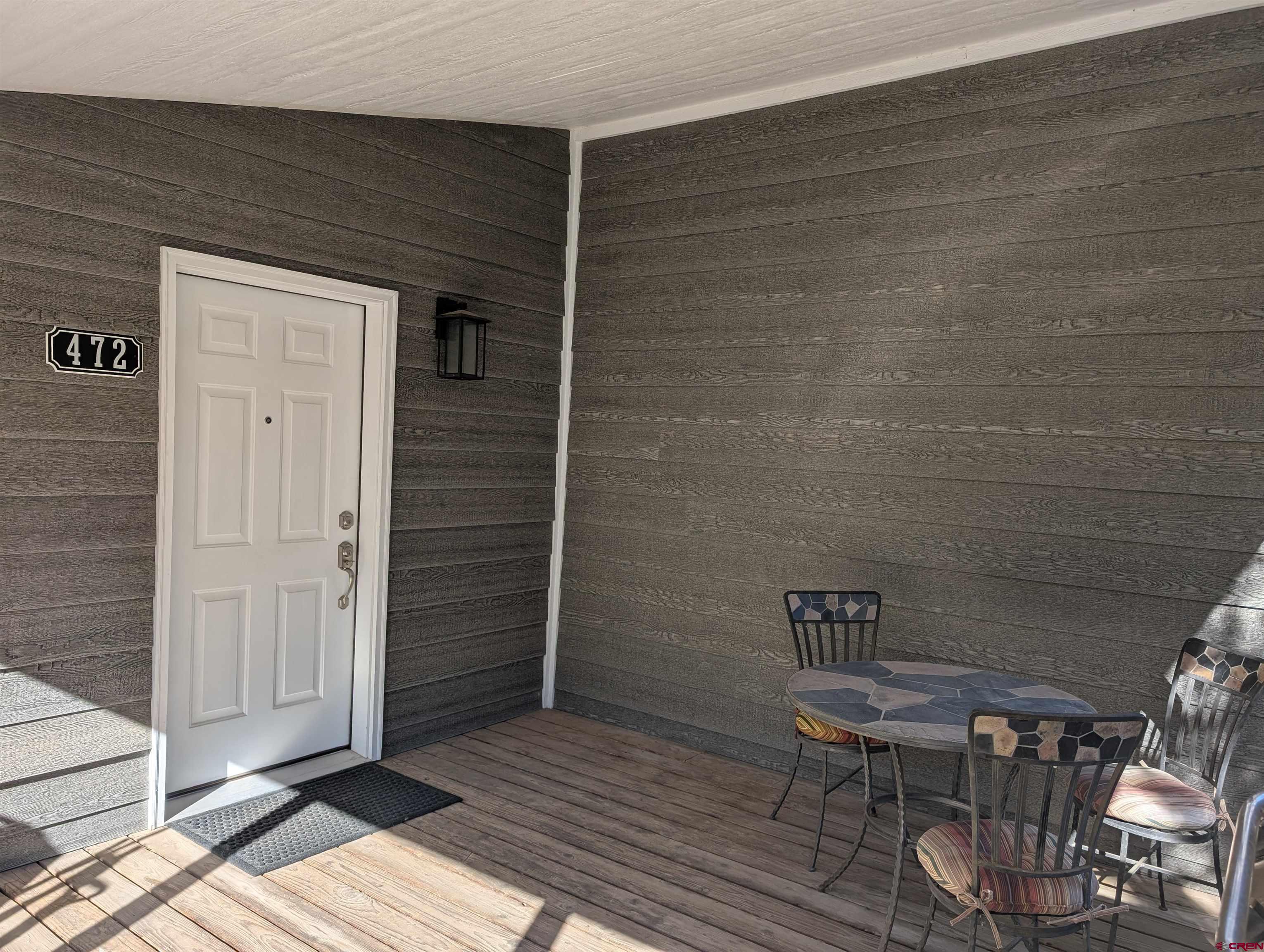 472 Haystack Circle Pagosa Springs, CO 81147 - Photo 25 of 31 a view of a wooden door and chair in the patio