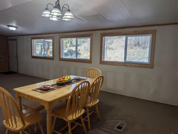 a dining room with furniture and chandelier