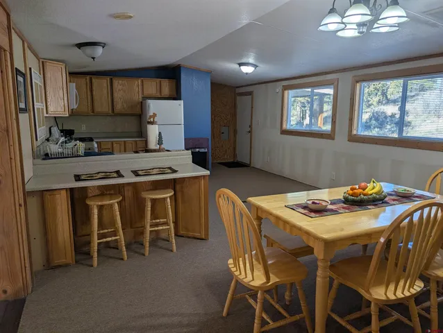 a kitchen that has a table and chairs in it