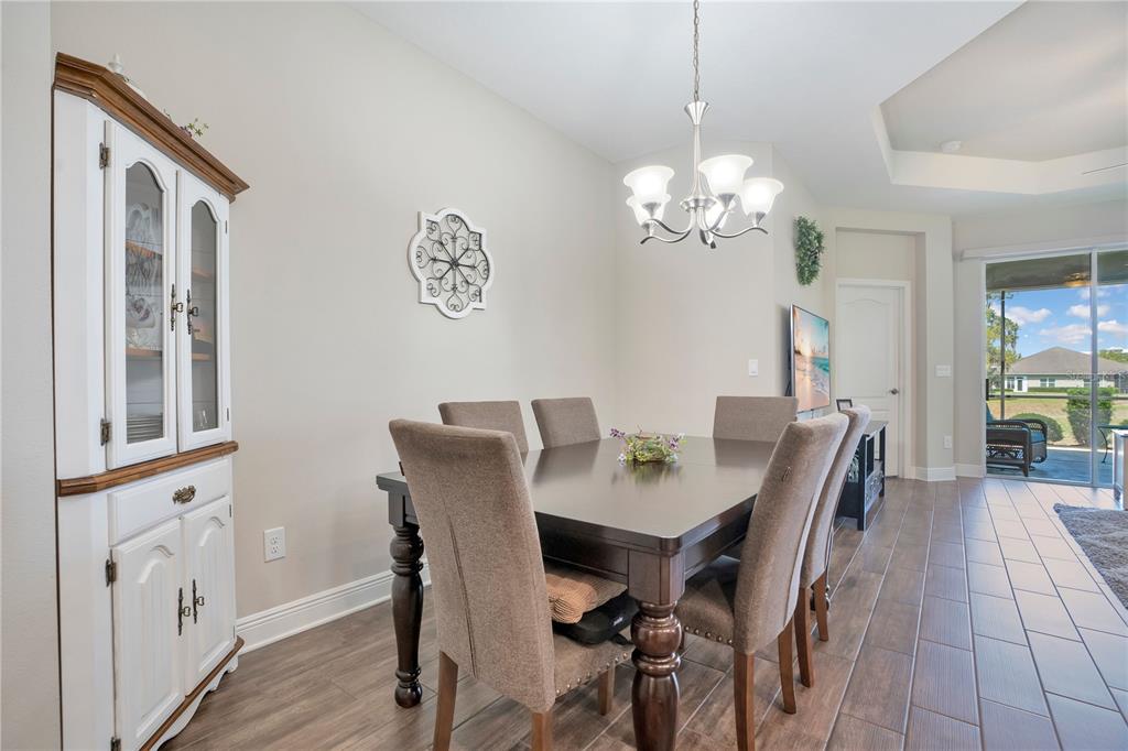 13541 Circa Crossing Drive Lithia, FL 33547 - Photo 11 of 52 a view of a dining room with furniture a chandelier and wooden floor