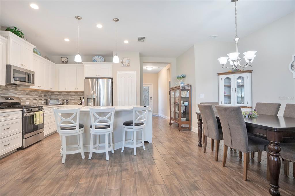 13541 Circa Crossing Drive Lithia, FL 33547 - Photo 16 of 52 a view of a dining room with furniture and wooden floor