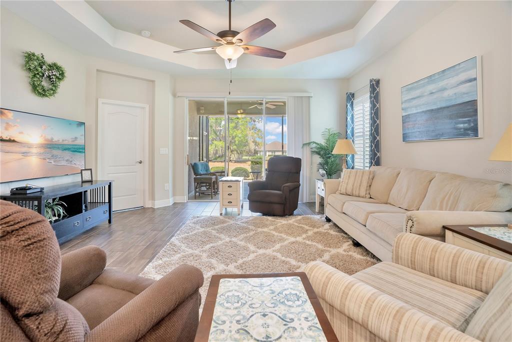 13541 Circa Crossing Drive Lithia, FL 33547 - Photo 20 of 52 a living room with furniture a large window and a flat screen tv