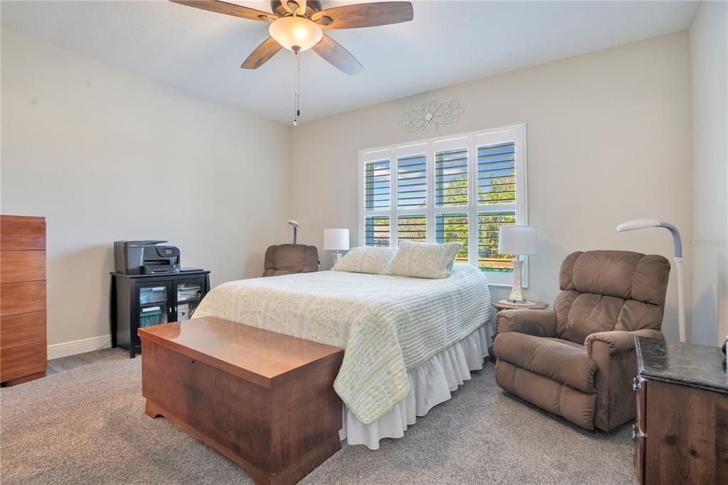 13541 Circa Crossing Drive Lithia, FL 33547 - Photo 22 of 52 a bedroom with a bed and a chandelier