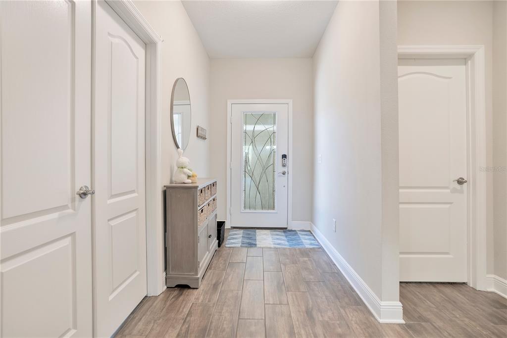13541 Circa Crossing Drive Lithia, FL 33547 - Photo 5 of 52 a view of a hallway with wooden floor and closet