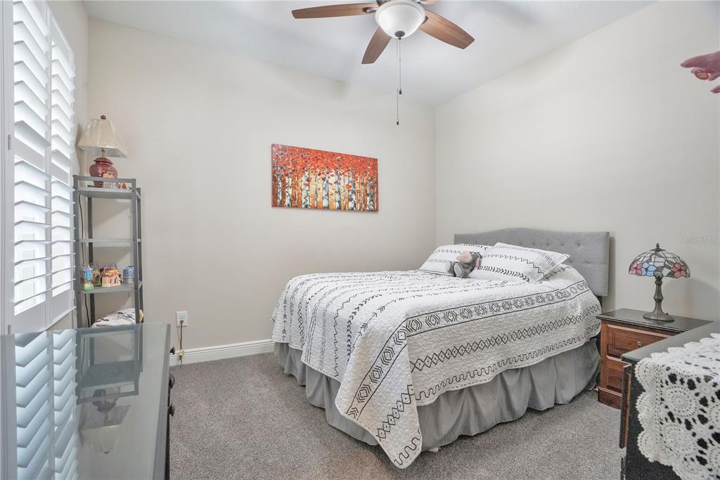13541 Circa Crossing Drive Lithia, FL 33547 - Photo 6 of 52 a bedroom with a bed and a chandelier
