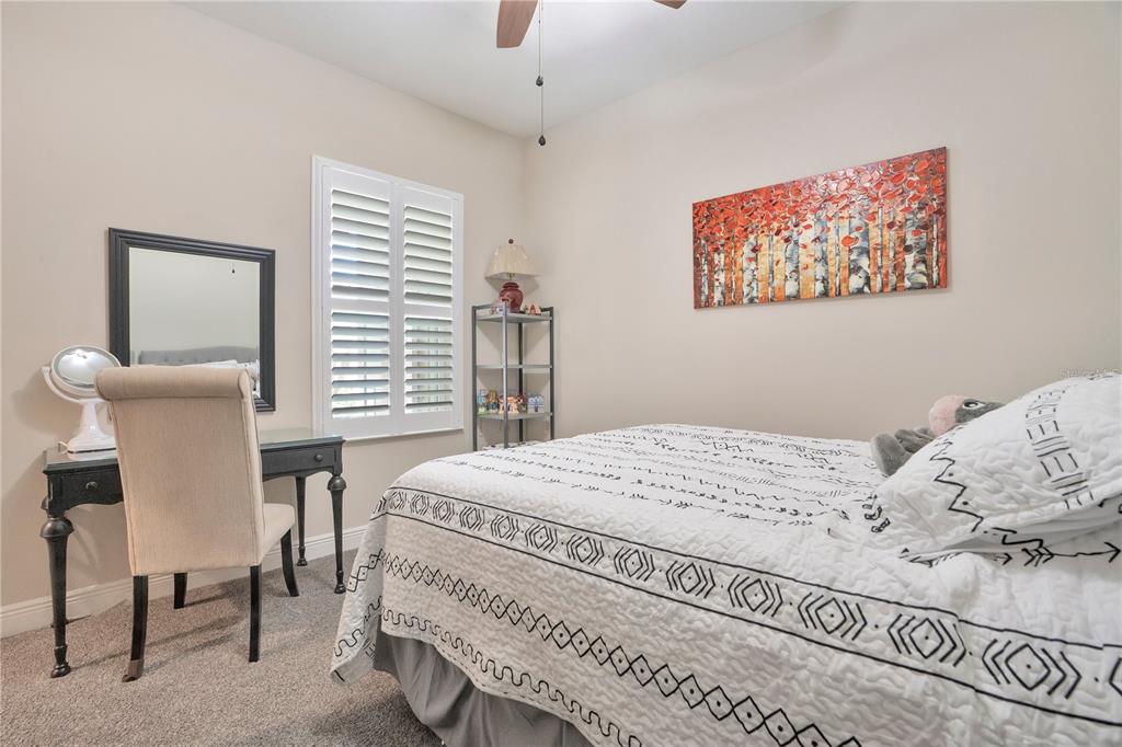 13541 Circa Crossing Drive Lithia, FL 33547 - Photo 7 of 52 a bedroom with a bed and a chair