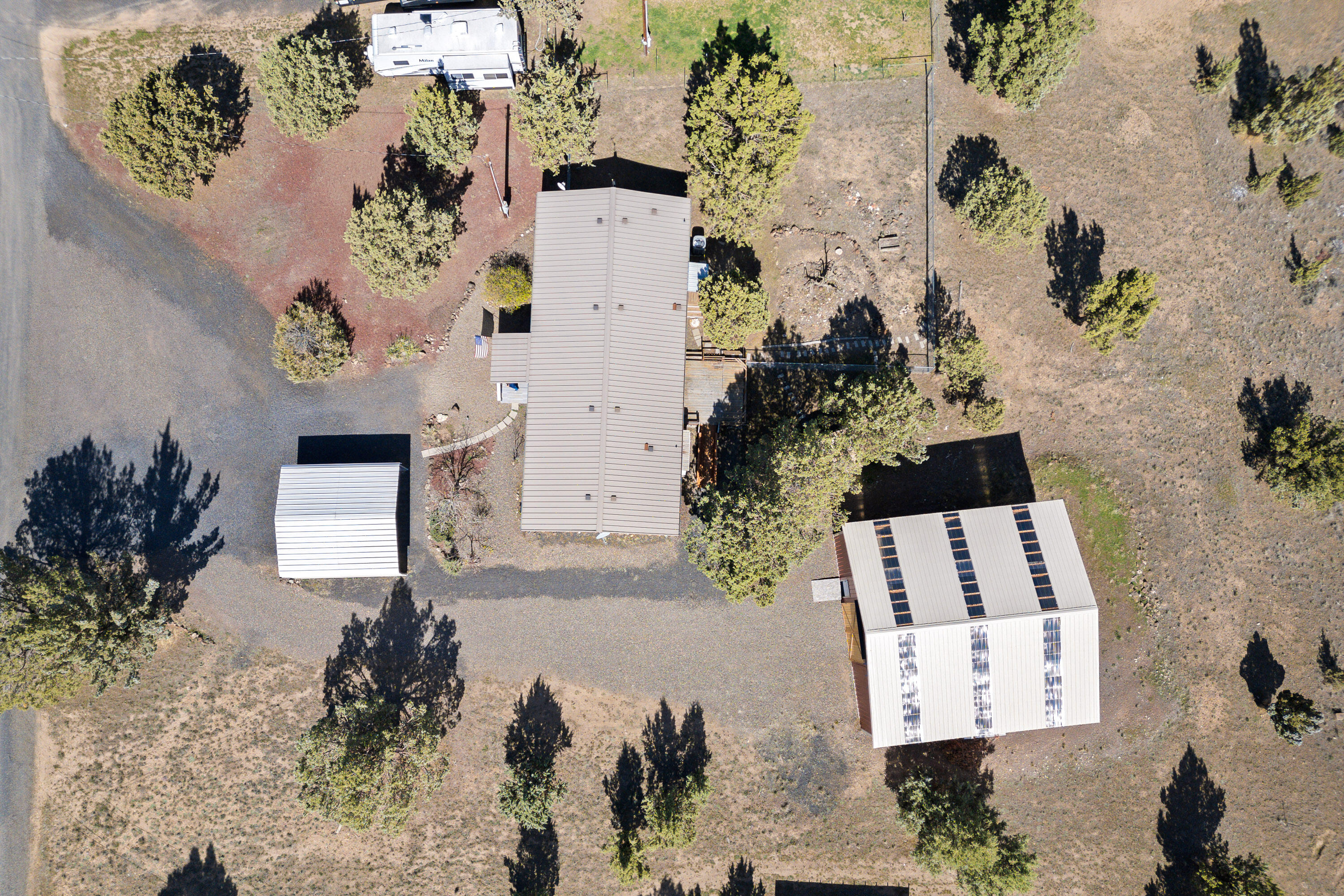 5674 Southeast Davis Loop Prineville, OR 97754 - Photo 48 of 48 an aerial view of a house with a yard and a large tree