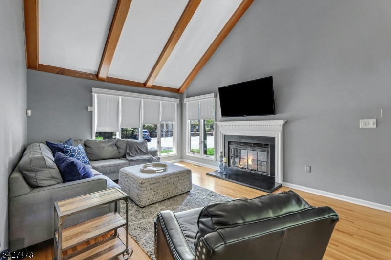 100 Easedale Road, Unit 100 Wayne, NJ 07470 - Photo 7 of 43 a living room with furniture and a fireplace