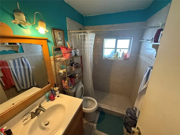 a bathroom with a sink toilet and shower
