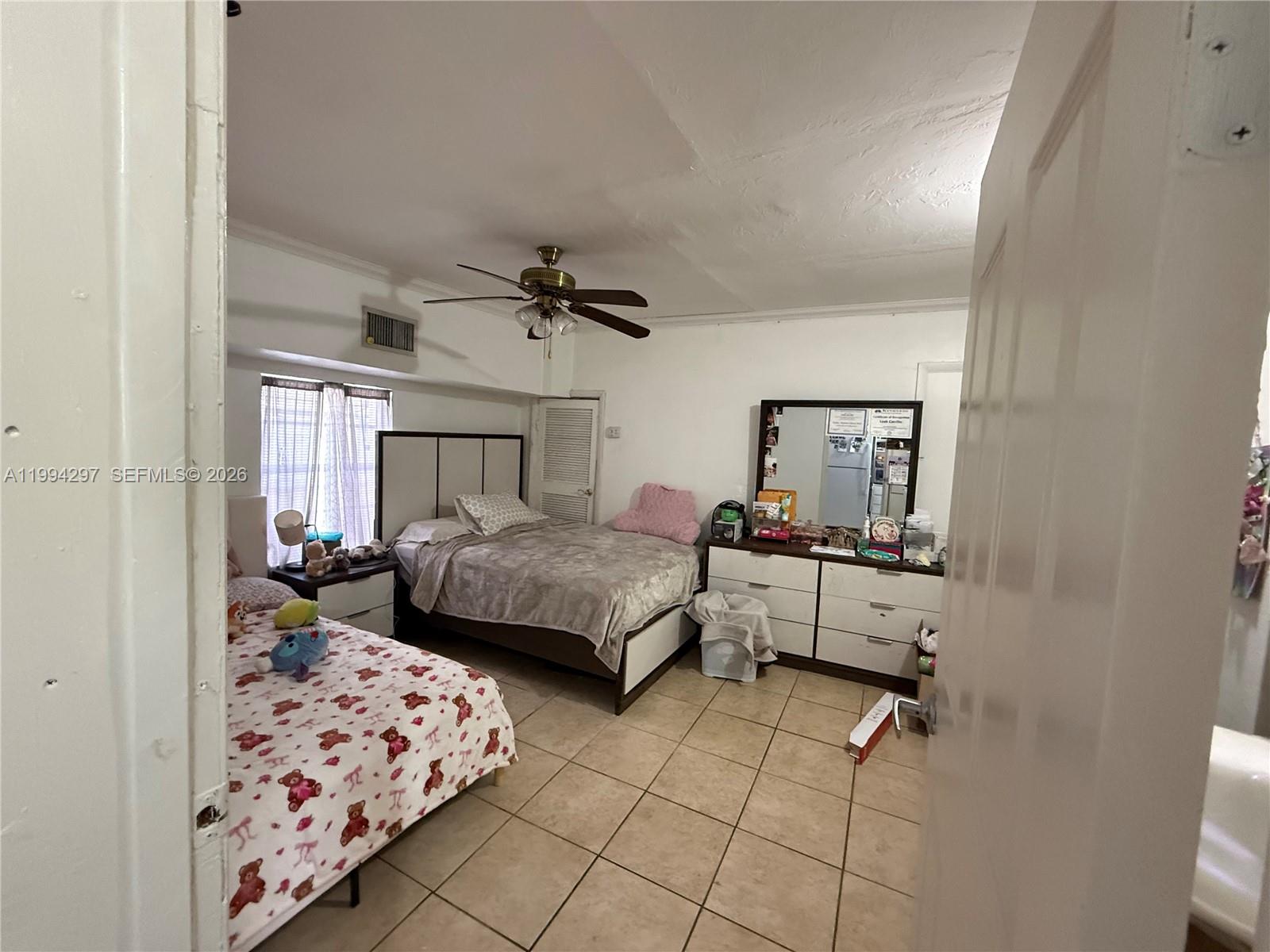 3674 Southwest 25th Street Miami, FL 33133 - Photo 12 of 15 a bedroom with a bed and wooden floor