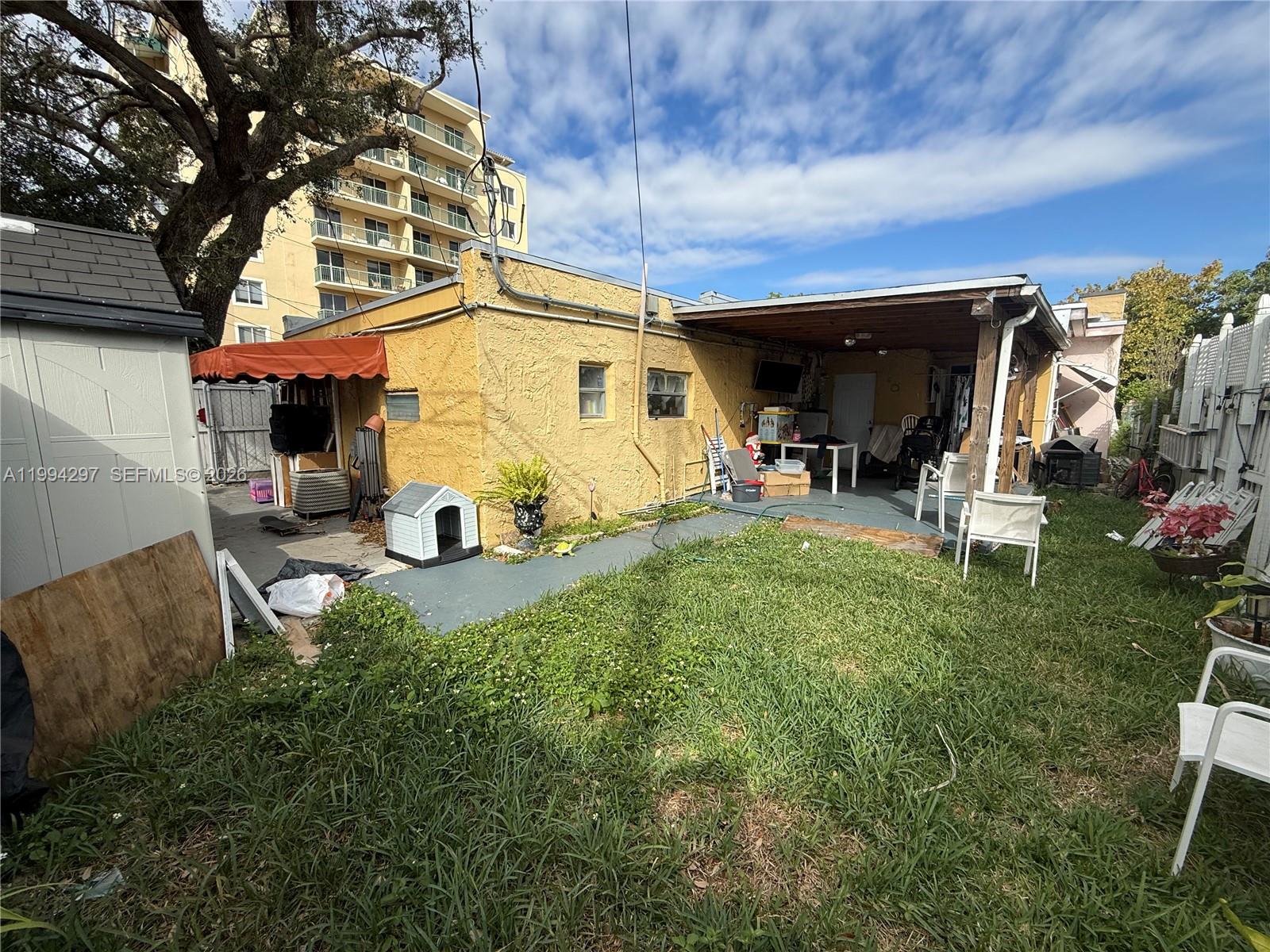 3674 Southwest 25th Street Miami, FL 33133 - Photo 15 of 15 a view of a porch with couches table and chairs under an umbrella