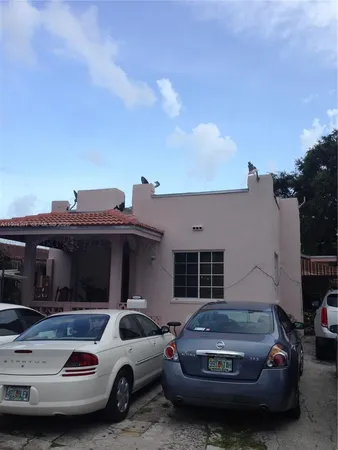 a view of a car parked in front of a house