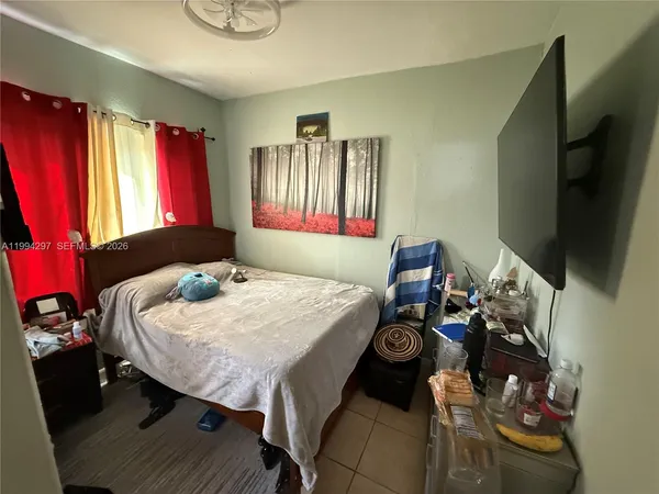 a bed sitting in a bedroom next to a window