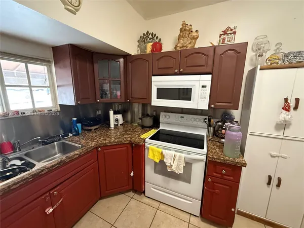 a kitchen with stainless steel appliances a stove sink and microwave