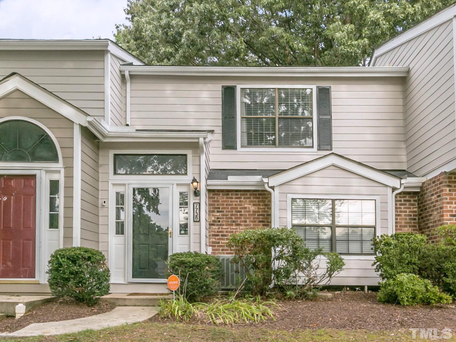 7738 Falcon Rest Circle Raleigh, NC 27615 - Photo 1 of 18 a front view of a house with garden