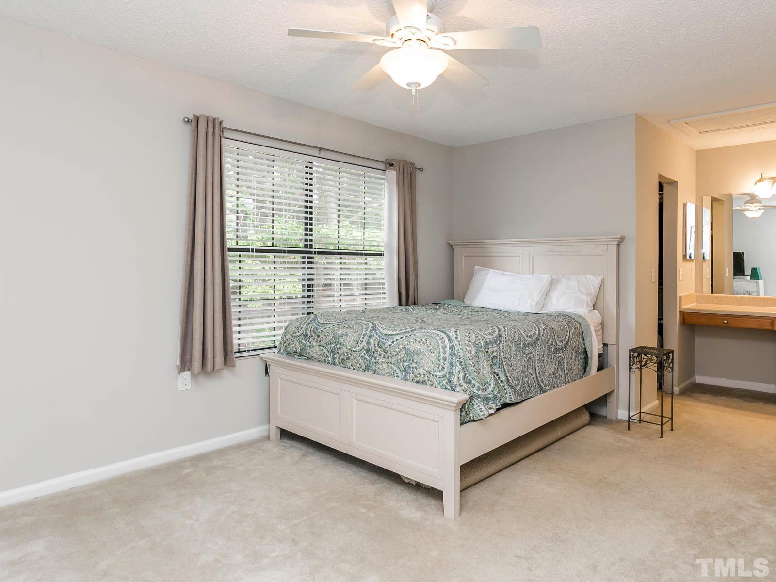 7738 Falcon Rest Circle Raleigh, NC 27615 - Photo 11 of 18 a bedroom with a bed and window