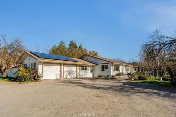 a front view of a house with a yard and outdoor seating