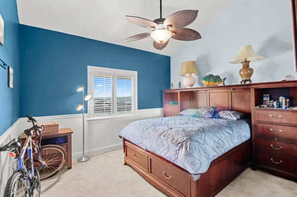 a bedroom with a bed and a chandelier