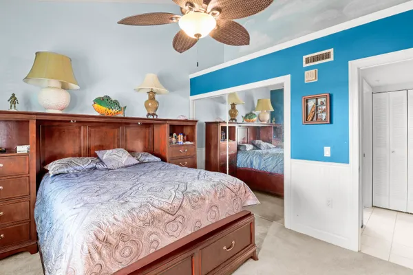 a bedroom with a bed and a painting on the wall