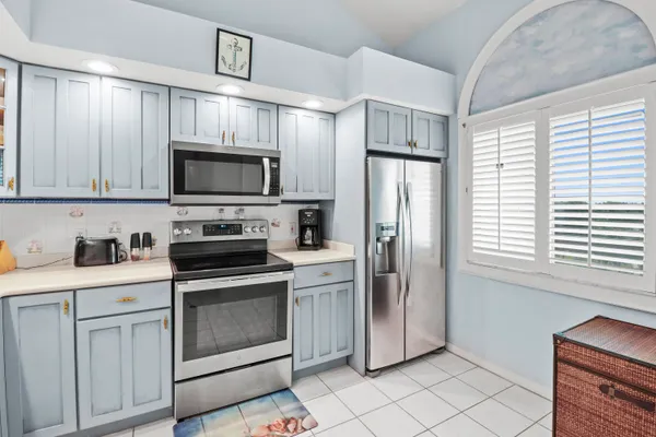 a kitchen with stainless steel appliances granite countertop a stove a refrigerator and a microwave