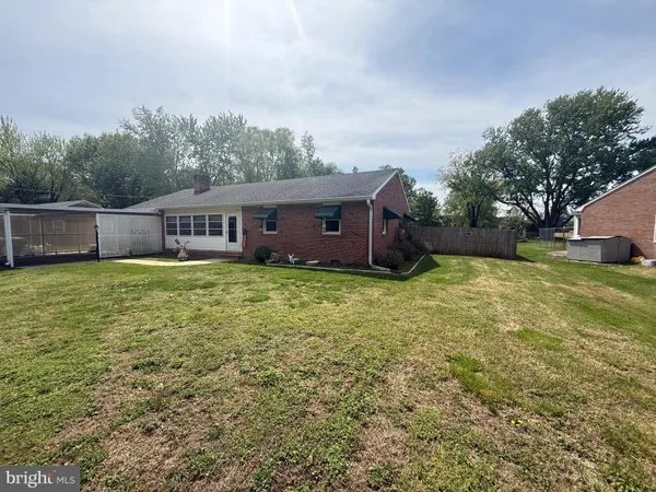a view of a house with yard and sitting area