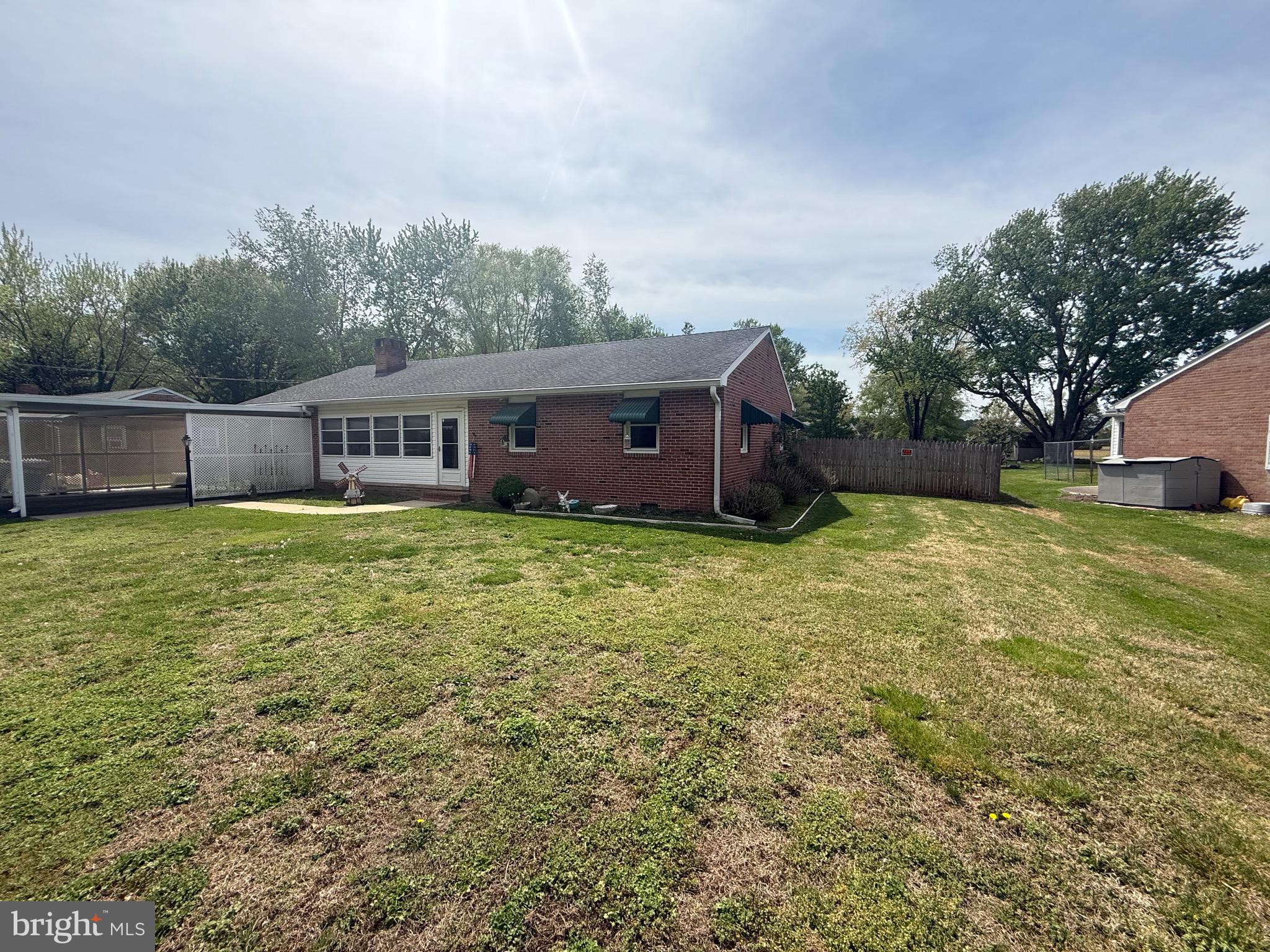 a view of a house with yard and sitting area