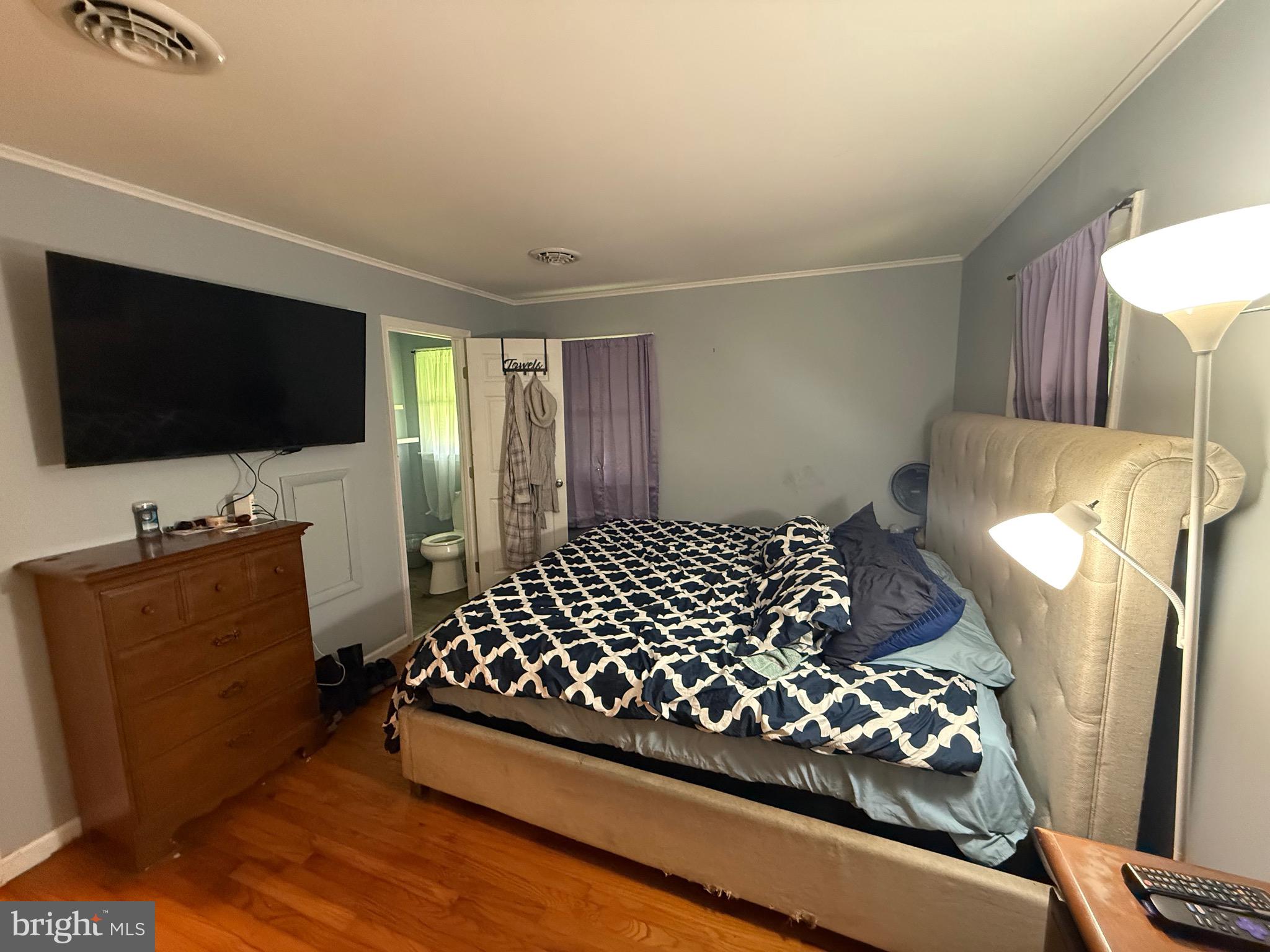 9108 Glebe Creek Road Easton, MD 21601 - Photo 8 of 19 a bedroom with bed and flat screen tv