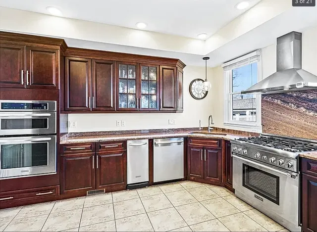 a kitchen with stainless steel appliances granite countertop a stove and a microwave