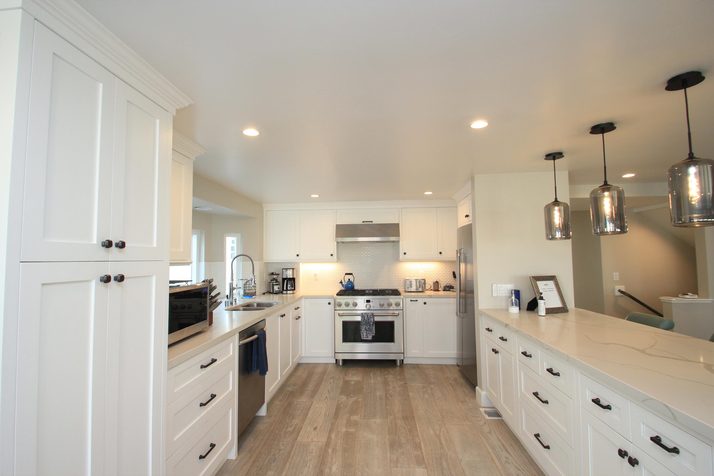 5235 Sealane Way Oxnard, CA 93035 - Photo 15 of 57 a kitchen with white cabinets and stainless steel appliances