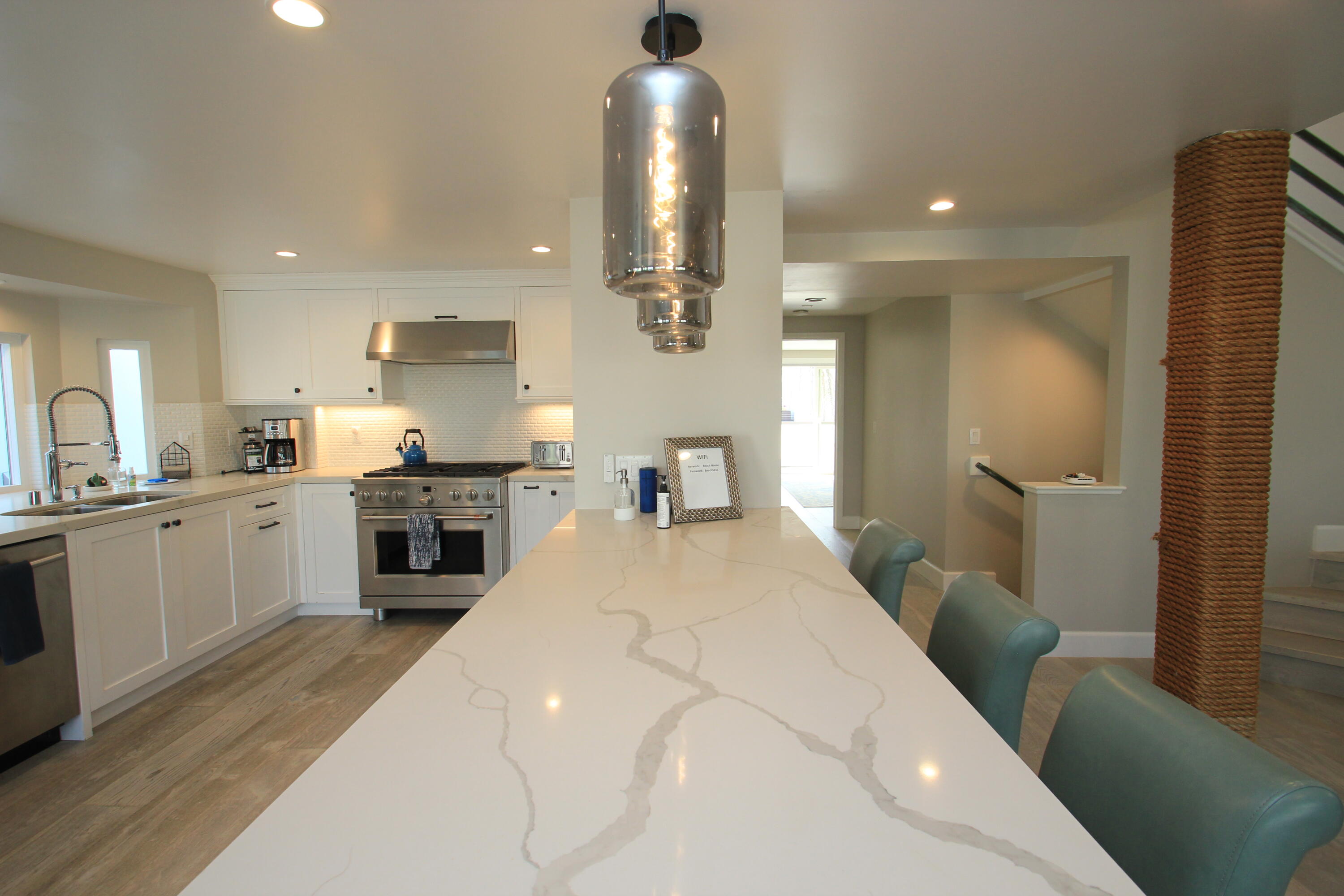 5235 Sealane Way Oxnard, CA 93035 - Photo 19 of 57 a large white kitchen with a sink a stove and cabinets