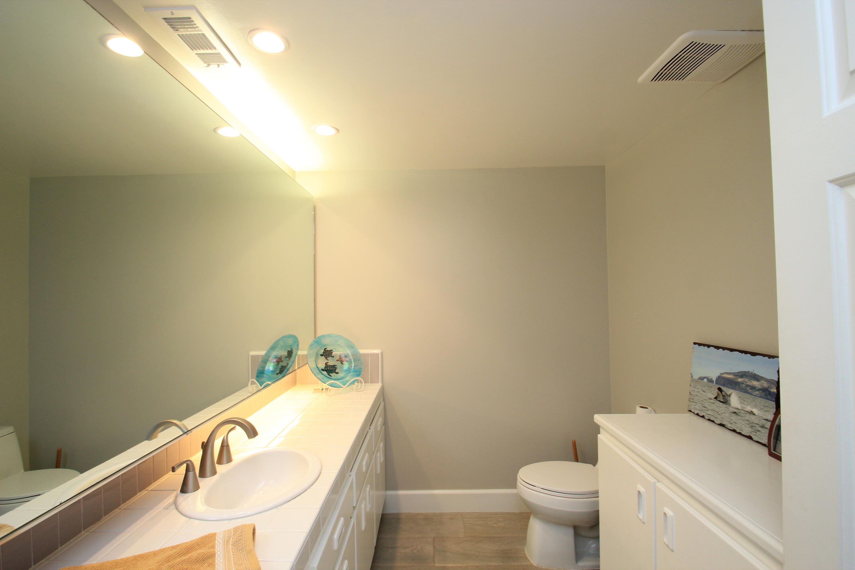 5235 Sealane Way Oxnard, CA 93035 - Photo 20 of 57 a bathroom with a granite countertop sink and a mirror
