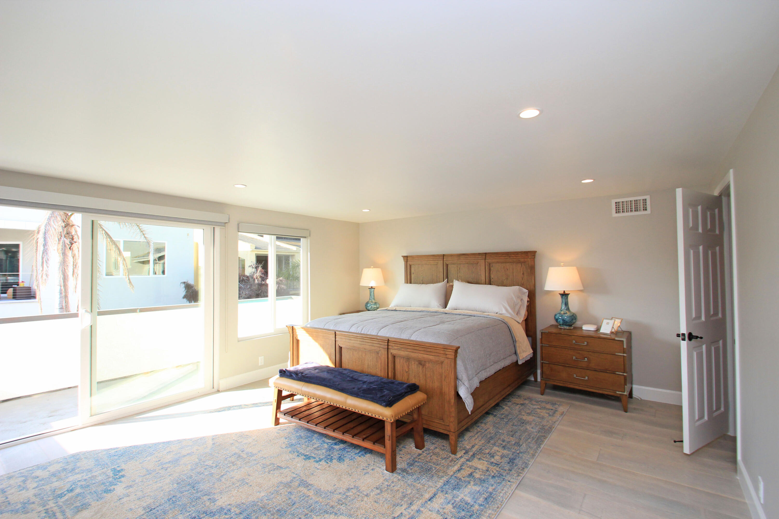 5235 Sealane Way Oxnard, CA 93035 - Photo 22 of 57 a bedroom with a bed lamp and a large window